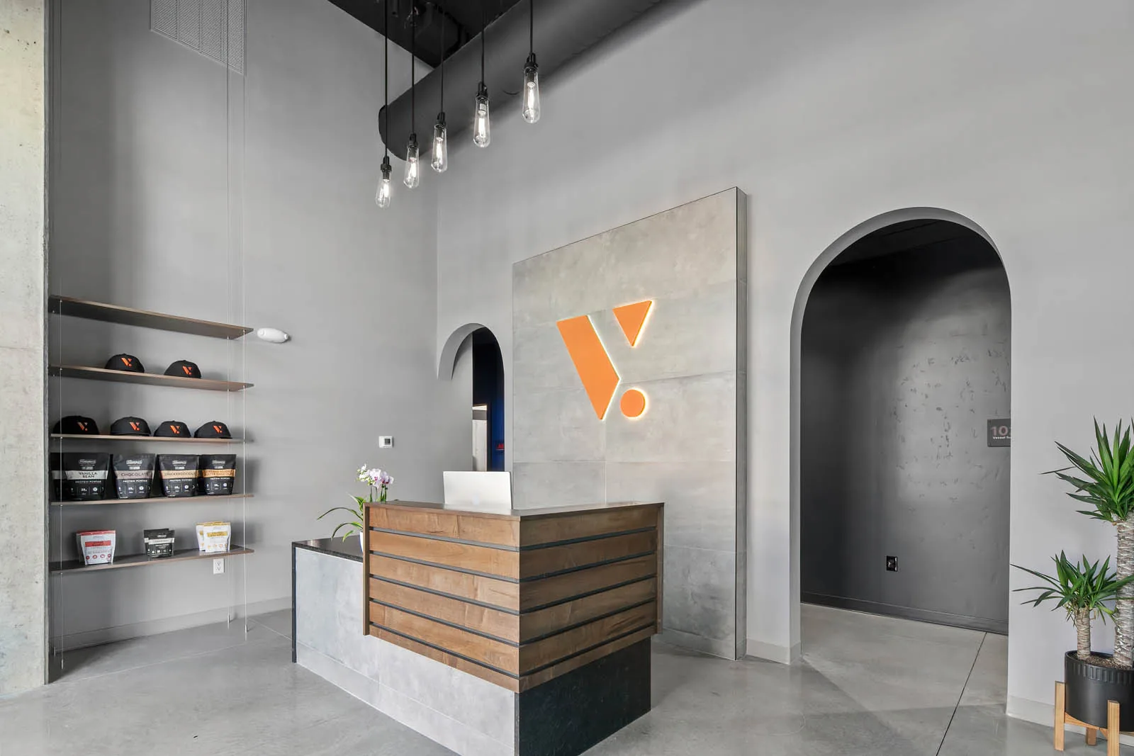 A finished commercial lobby with concrete and wood millwork