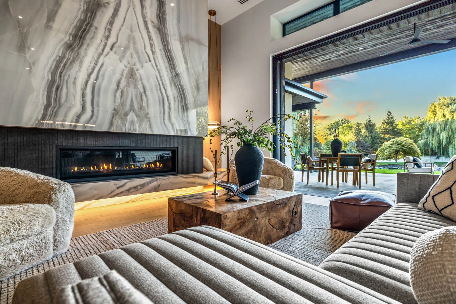 A finished living room with a full height stone fireplace